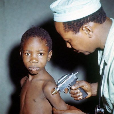 Doctor vaccinating young boy