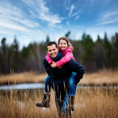 Father carrying daughter on shoulders