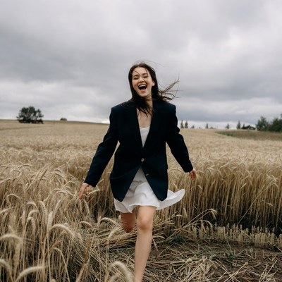 Woman running joyfully in wheat field