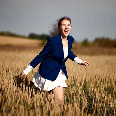 Young woman running in wheat field