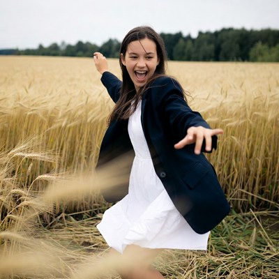 Girl dancing in wheat field