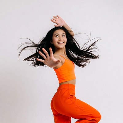 Asian girl dancing in orange outfit