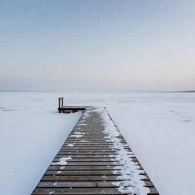 Wooden pier on frozen lake