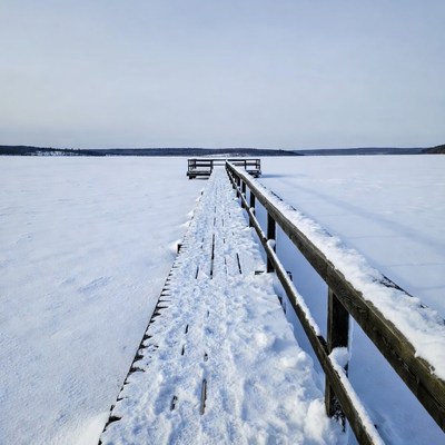 Wooden pier on frozen lake