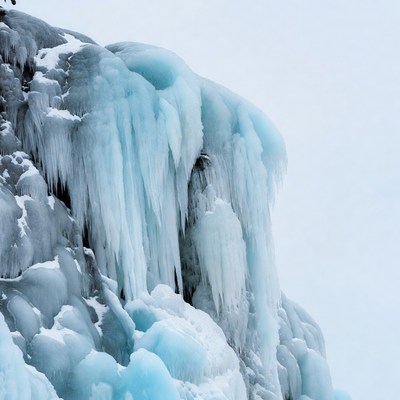 Icicles Hanging on Snowy Cliff