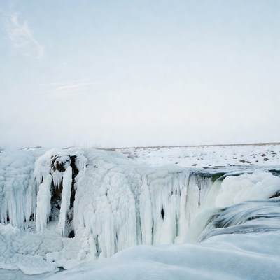 Frozen Waterfall in Snowy Landscape