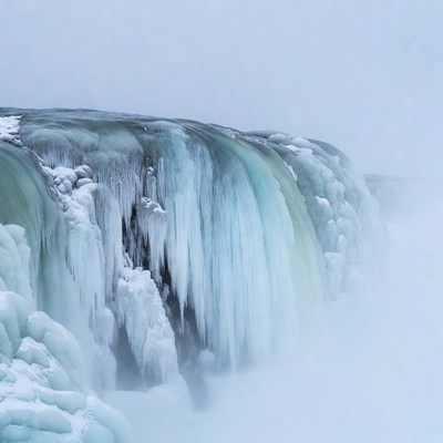 Frozen Waterfall in Snowy Mist