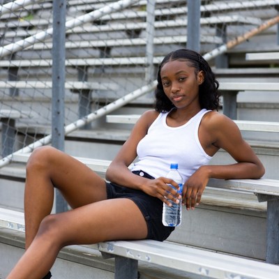 African-American woman on bleachers with water bottle