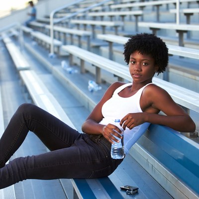 African-American woman on stadium bleachers