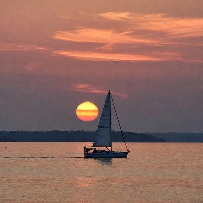 Sailboat with man at sunset