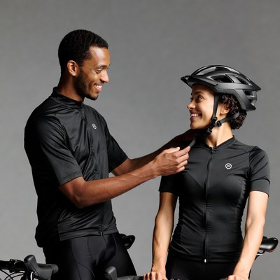 African-American couple adjusting bike helmets