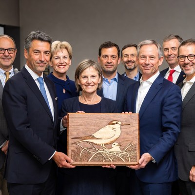 Group holding wooden bird plaque