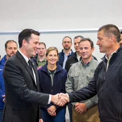 Men shaking hands with group
