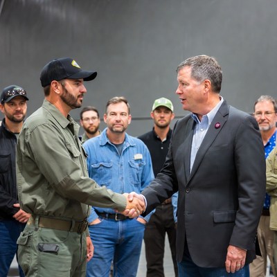 Military man shaking hands with suit man