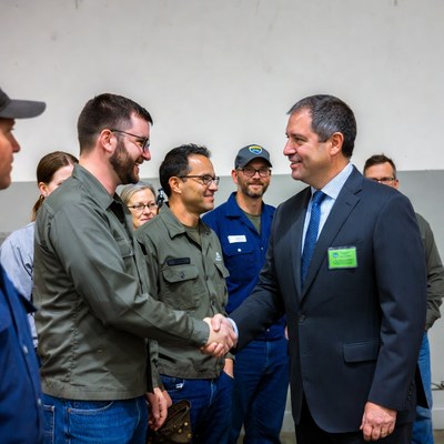 Businessman shaking hands with workers