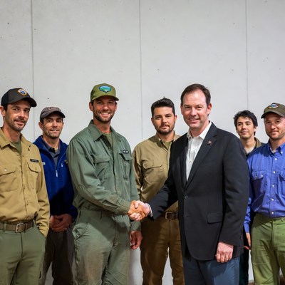 Men in work uniforms shaking hands