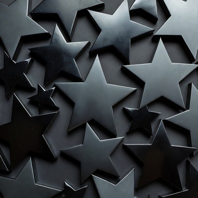 Black star shapes scattered on dark background