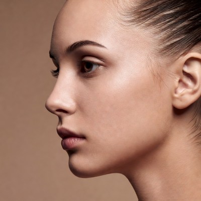 Woman's profile on beige background