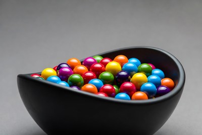Colorful candies in black bowl
