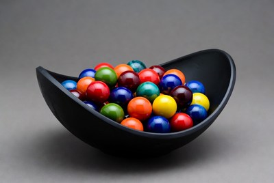Colorful marbles in black bowl