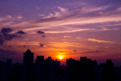 Sunset over city skyline silhouette