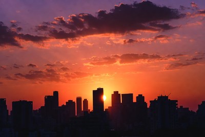 Sunset over City Skyline Silhouette
