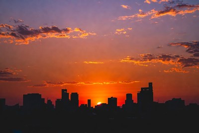 Sunset over city skyline silhouette