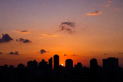 Sunset Behind City Skyline Silhouette