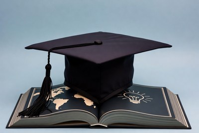 Graduation Cap on Open Book with Globe