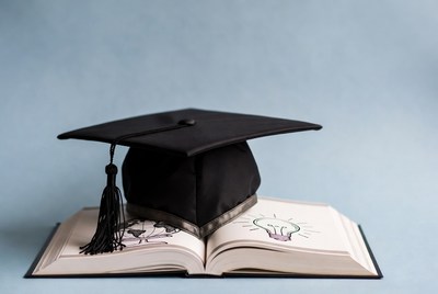 Graduation Cap on Open Book with Lightbulb
