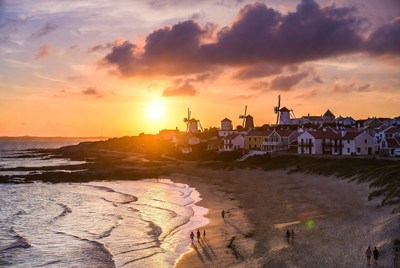 Windmills and village at sunset beach