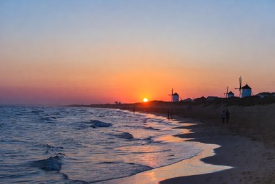 Sunset Beach with Windmills and Couple