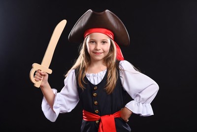 Girl in pirate costume with wooden sword