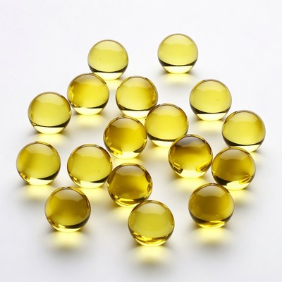 Yellow Vitamin Capsules on White Background