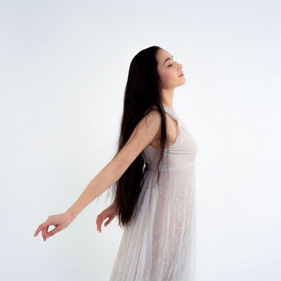 Asian woman dancing in sheer dress