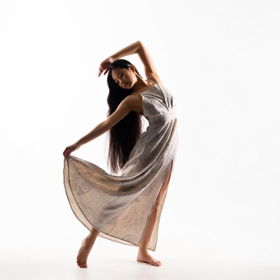 Asian woman in flowing dress dance pose
