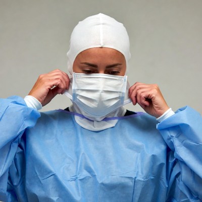 Woman adjusting surgical mask