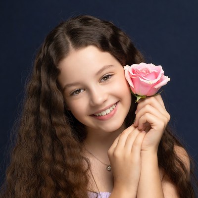 Girl holding pink rose