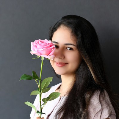 Woman holding pink rose