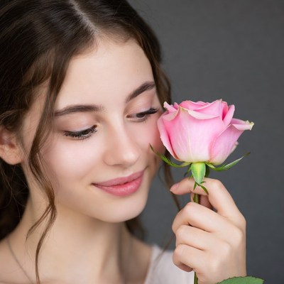 Woman smelling pink rose