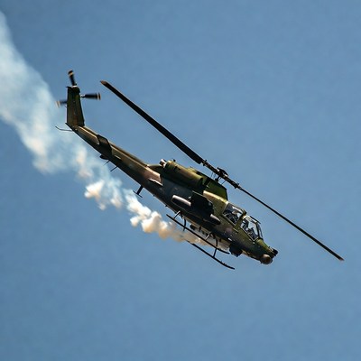 AH-64 Apache Helicopter Flying with Smoke