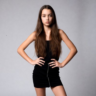 Teen girl posing in black dress