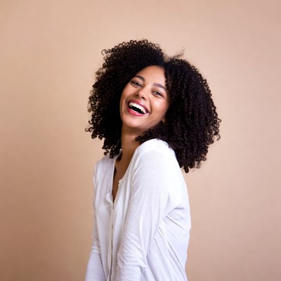 African-American woman laughing with curly hair
