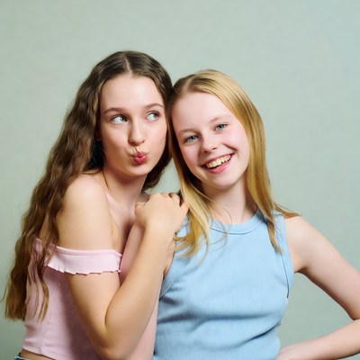 Two girls kissing playfully