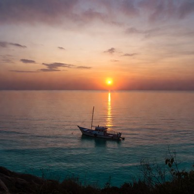 Fishing Boat at Sunset Over Sea