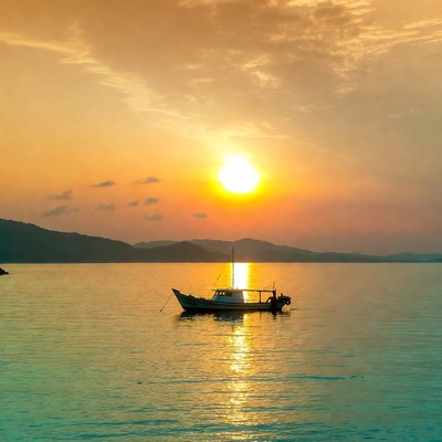 Fishing Boat at Sunset over Sea