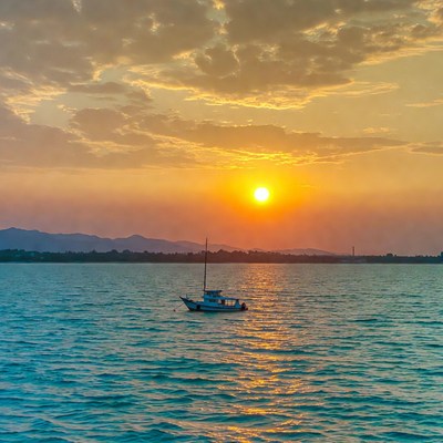 Sailboat on lake at sunset