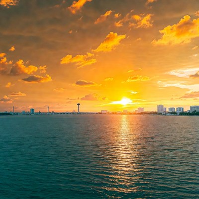 Sunset over city skyline and water