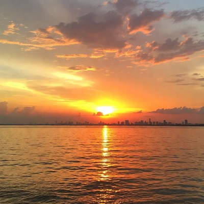 Sunset over city skyline and water