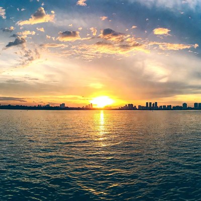 Sunset over city skyline and water
